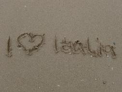 I love italy, lettering on wet sand