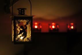 Close-up of the beautiful lantern with angel shape, at background with colorful lighting, in the evening