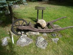 wheelbarrow with stones on the grass in sweden