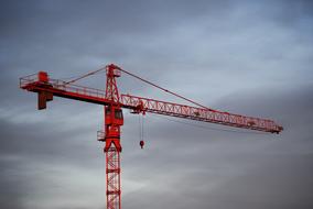 Red crane under the sky with dark clouds
