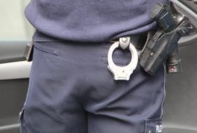 handcuffs and weapons on the policeman's belt