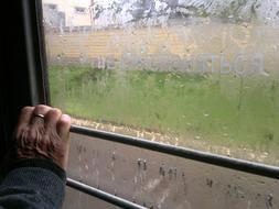 Hand on window at Rainy day