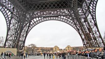 tourists in the square near the eiffel tower in paris