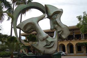 sculpture in the form of masks on the square in the park