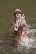 Young Woman Playing with water splashes