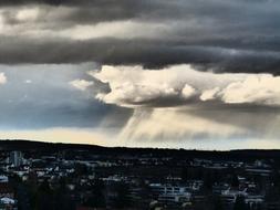 rain clouds over the city at dusk