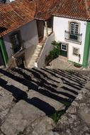 Beautiful landscape with the stairs, near the colorful houses, in sunlight, in Ãbidos, Portugal