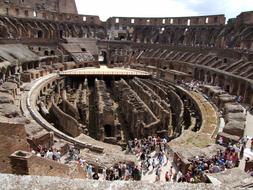 Landscape of the Colosseum with people, in Rome, Italy, under the blue sky with white clouds