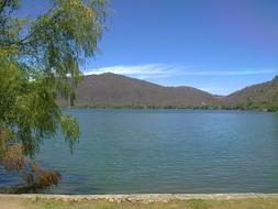 Beautiful and colorful landscape of the lagun with mountains, in Mexico, under the blue sky with white clouds