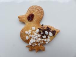 Beautiful and colorful Easter cookie in duck shape, on the white surface