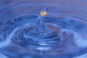 Drip of Blue Liquid over surface, macro