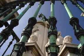 Beautiful architecture with statues in Baixa, Lisbon, Portugal, in sunlight, under the blue sky