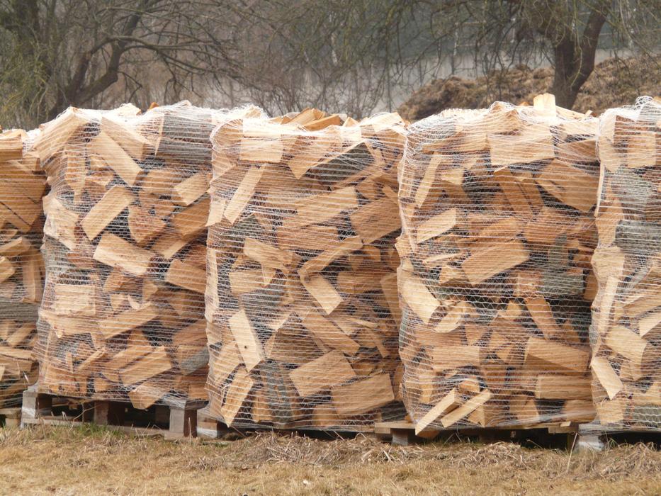 chopped firewood in nets on the field