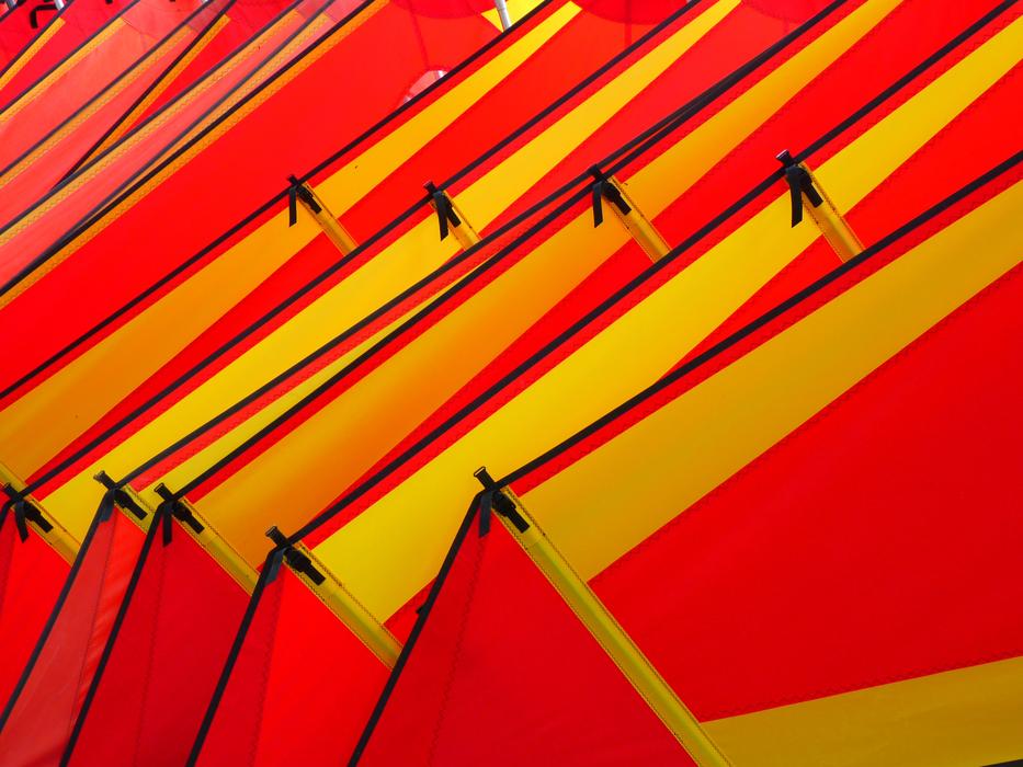 Close-up of the red and yellow sails for wind surfing, in light