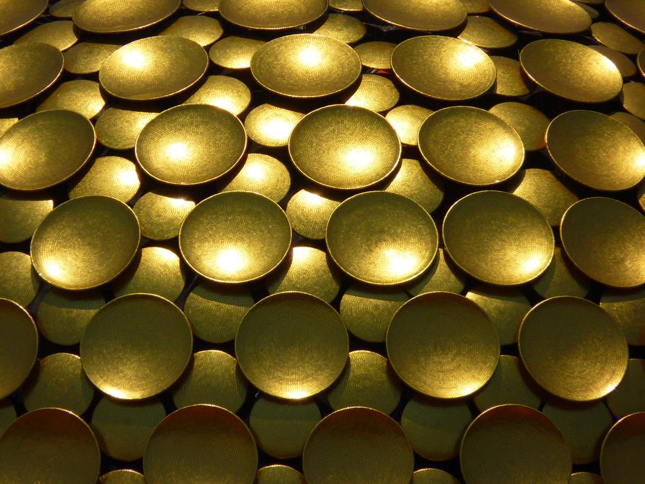 Close-up of the shiny, patterned, golden dome of the Aurobindo Ashram