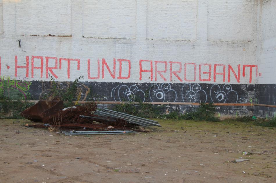 graffiti with red lettering on an abandoned building