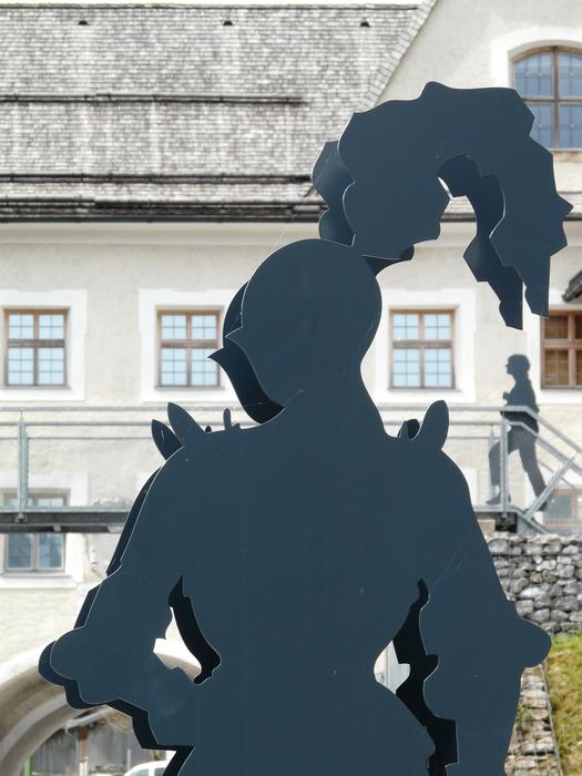 metal figure of a knight on the background of the house