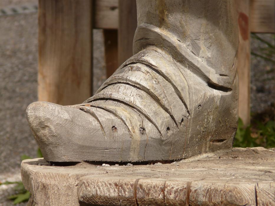 foot in wooden shoes as a sculpture