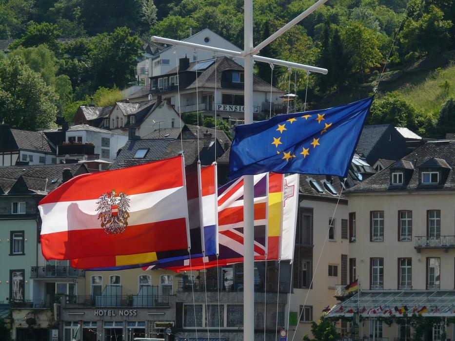 european state Flags on pole at city