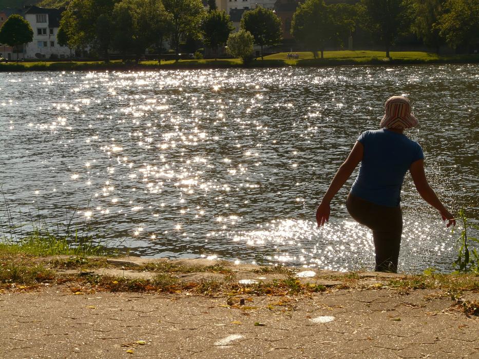 woman walks into the river in summer