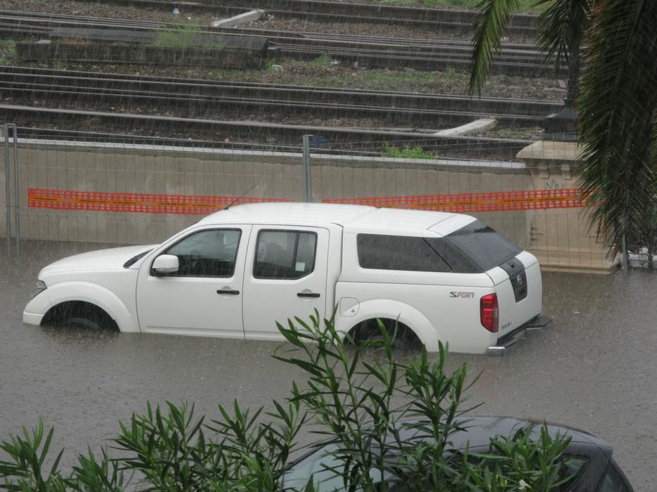 White car in the high water in Calabria, Italy, in 2010