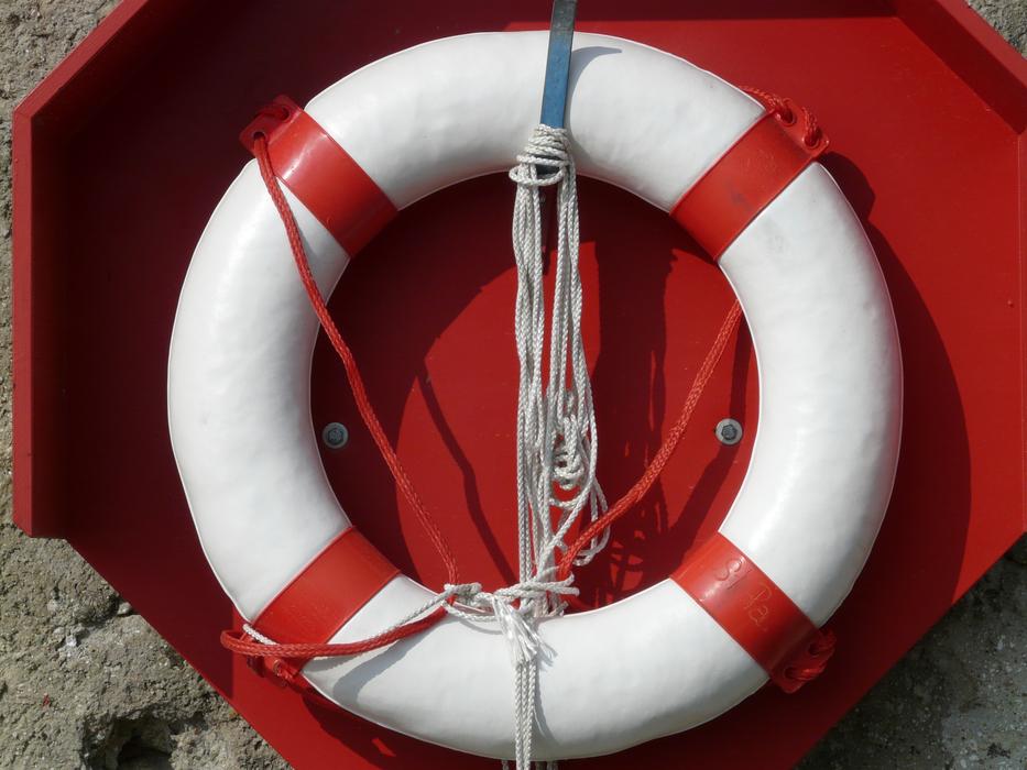 Red and white lifebuoy on the boat