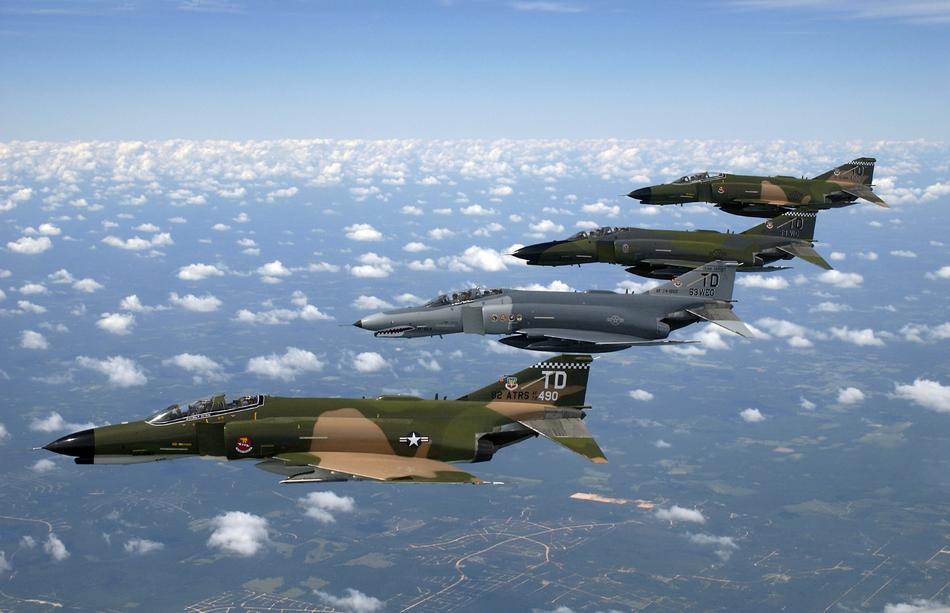 four us army Fighter Jets above clouds