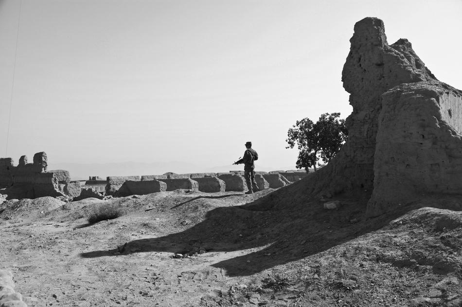 military patrol among the ruins in black and white background