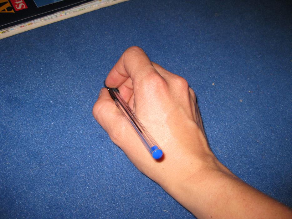 pen in hand on blue background