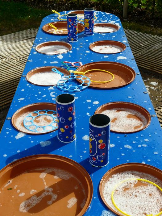 Colorful soap bubble cans on the bubble table