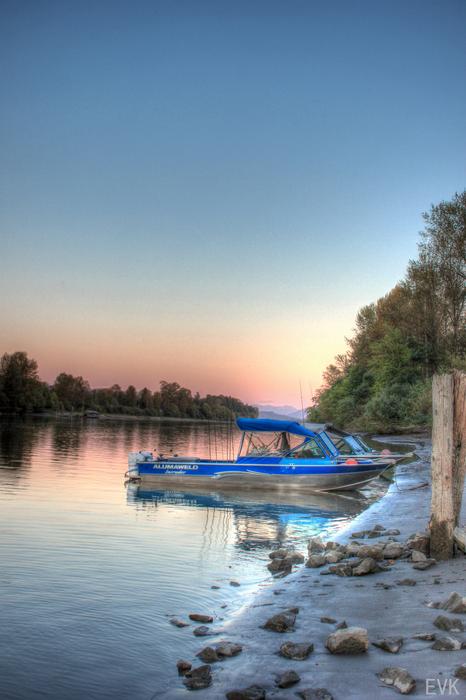 boat on the river bank in pink twilight