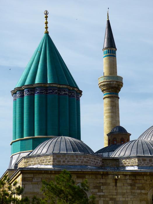Beautiful and colorful roof of the Mevlana Monastery in Konya, Turkey, at blue sky with white clouds on background