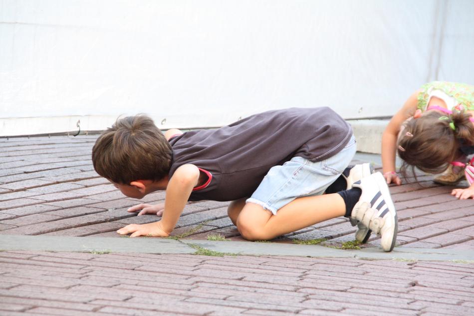 curious children kneel on the wooden floor