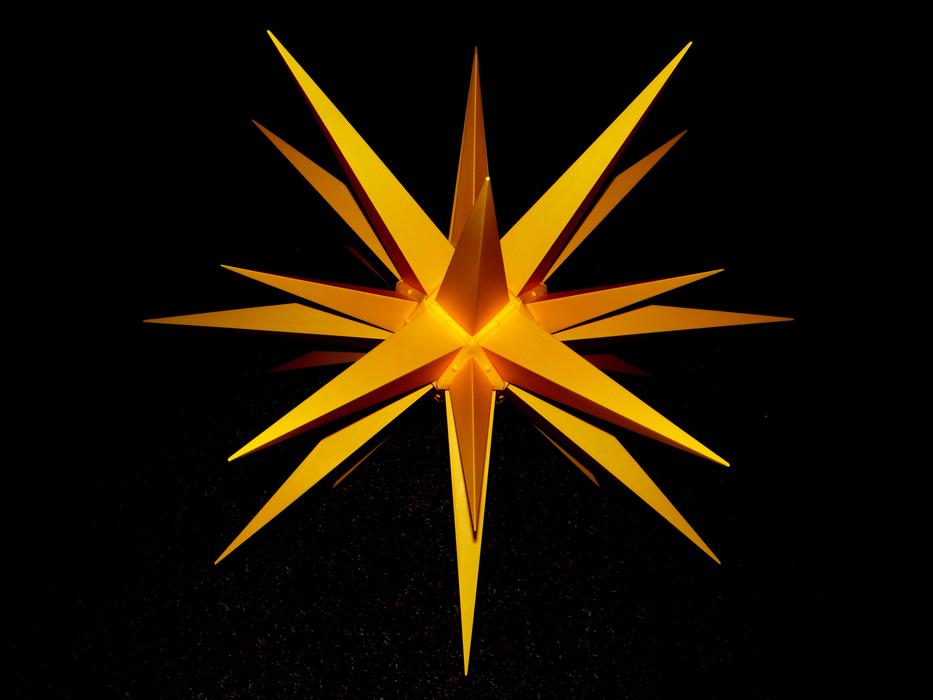 Beautiful, yellow and orange Poinsettia flower, at black background