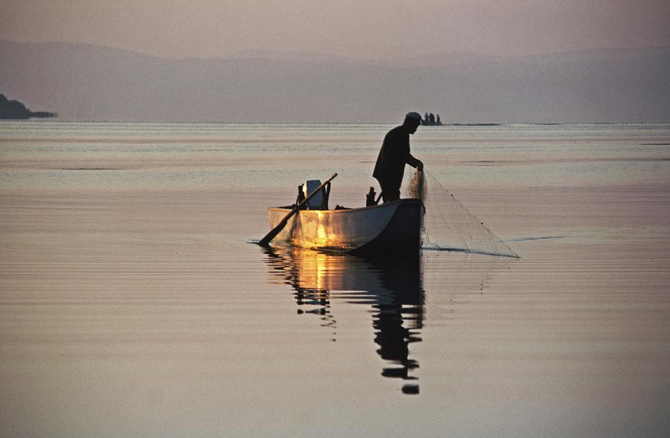 fisherman on boat in Lake Trasimene in Umbria