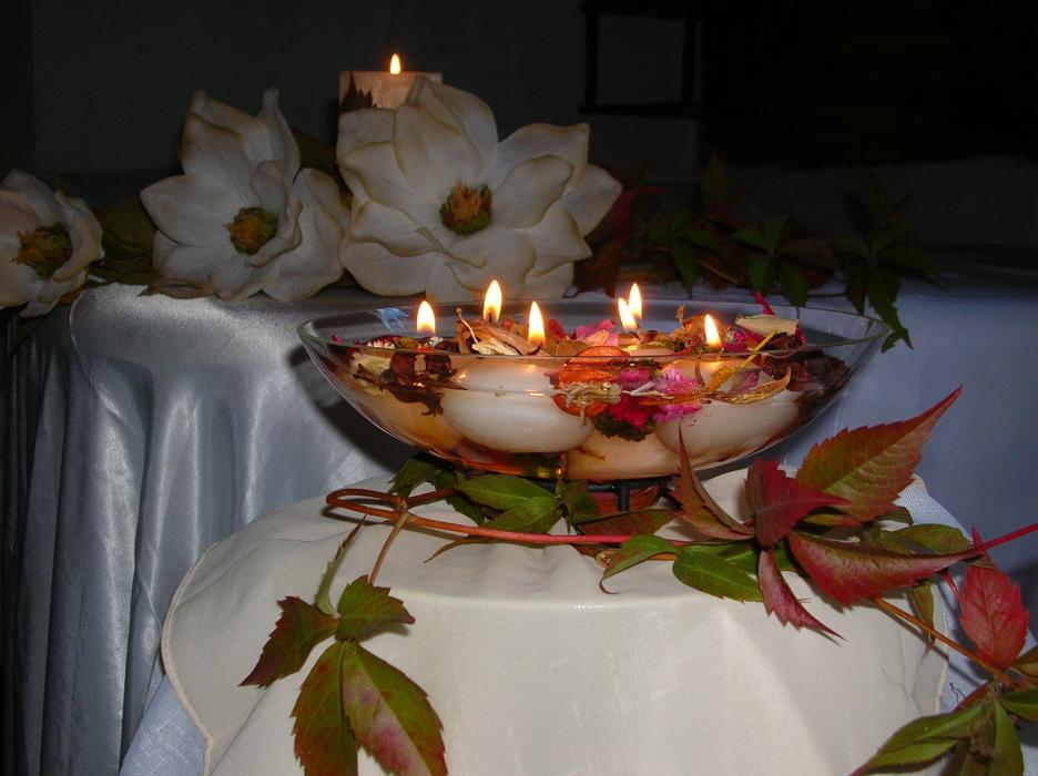composition of burning candles floating in a vase