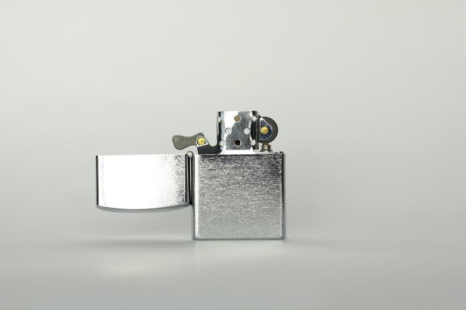 Beautiful, shiny silver lighter, at grey background