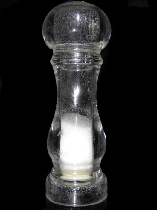 transparent salt shaker on black background