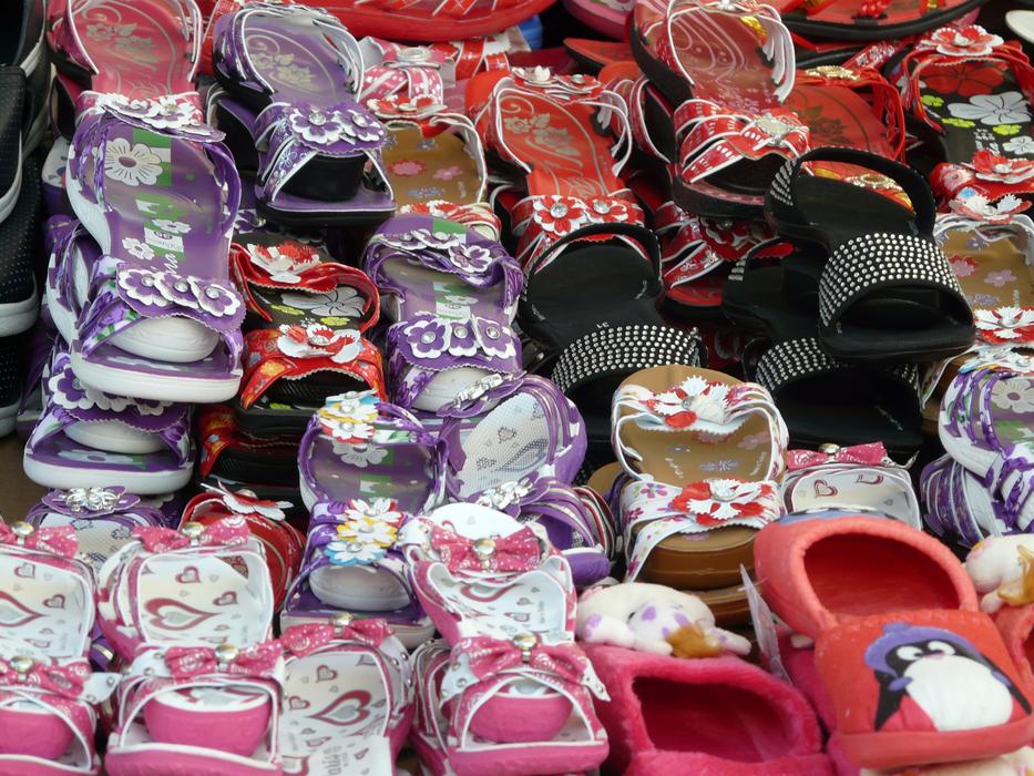 stack of colorful Sandals on market