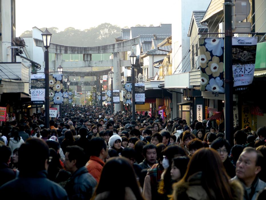 crowd of people on the street during the opening of shops