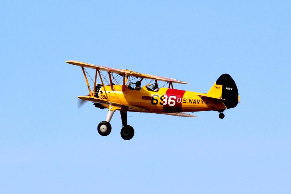 yellow biplane with propeller