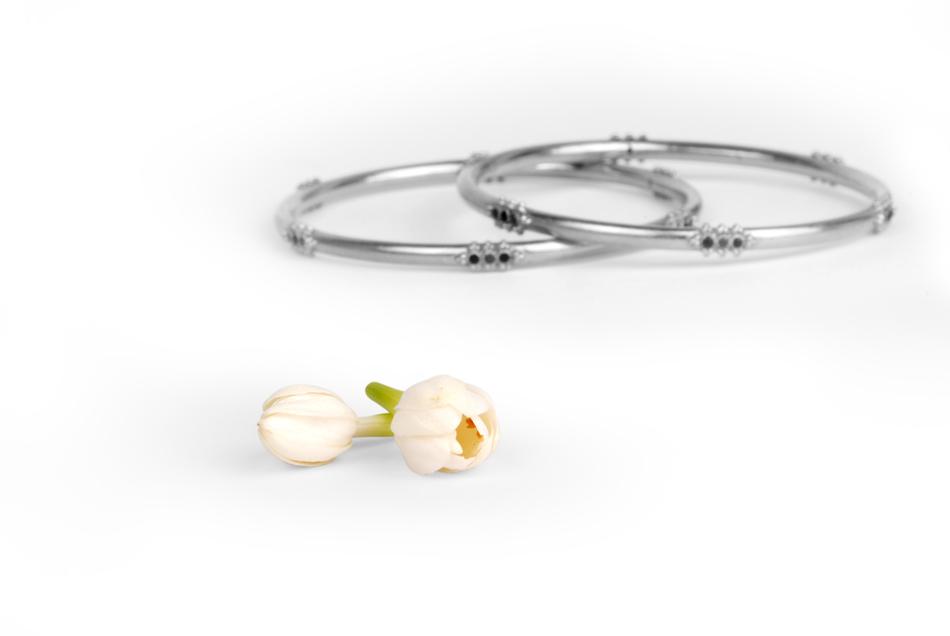 two metal Bracelets and white flowers