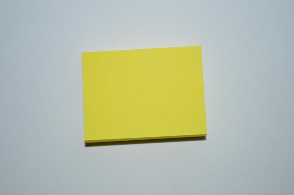 block of white Stickies at grey background