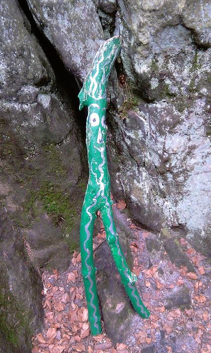 branch in green paint near the stone