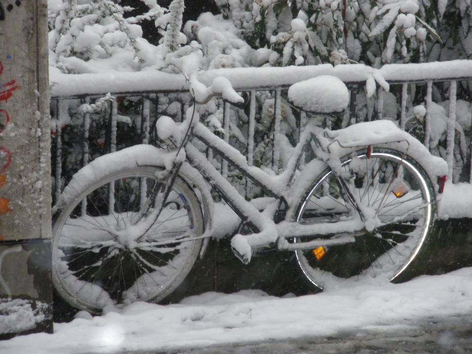 bike in the snow near the fence