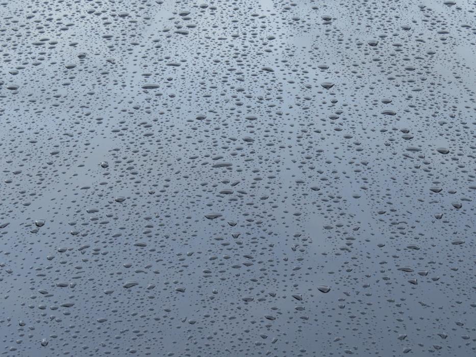 Close-up of the raindrops on the shiny glass