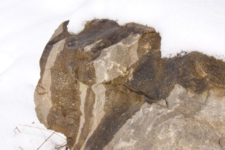 a stone among the snow in winter