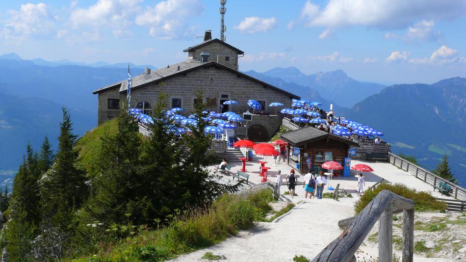 tourists near the building on the mountain