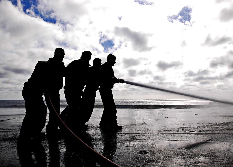 silhouettes of spraying on ship deck