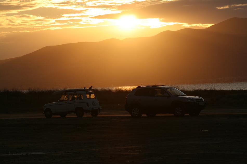 cars on the banks of the Ebro Delta at dusk